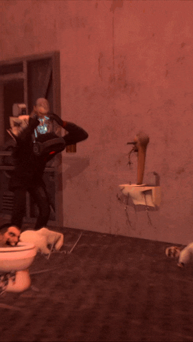 a man is laying in a toilet while another man stands behind him