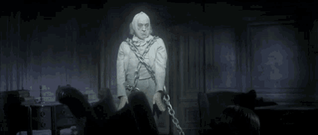 a ghost with chains around his neck is standing in the dark