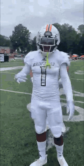 a football player wearing a white uniform with the number 1 on it