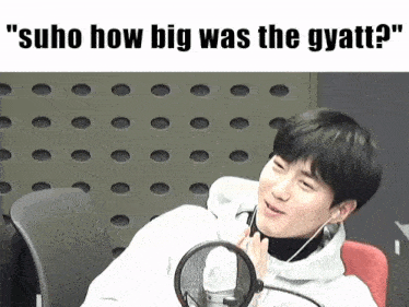 a picture of a man sitting in front of a microphone with the caption " suho how big was the gyatti "