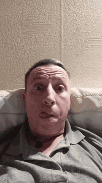 a man making a funny face while laying on a bed