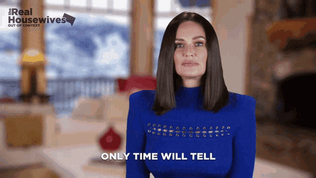 a woman in a blue sweater is talking about real housewives