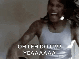 a woman in a white tank top is screaming with her mouth open and her hair blowing in the wind .