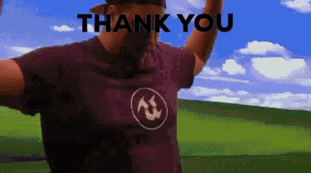 a man wearing a purple shirt with the word thank you on it