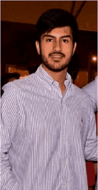 a man with a beard wearing a striped shirt