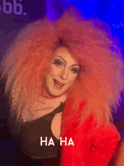 a drag queen with a big red hair and the words " ha ha " on the bottom