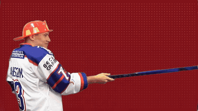 a man wearing a red hard hat and a jersey with the number 3 on the back