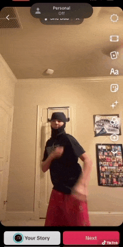 a man wearing a balaclava is dancing on a tiktok app