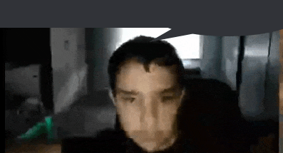 a man with a speech bubble above his head is sitting in front of a computer screen .