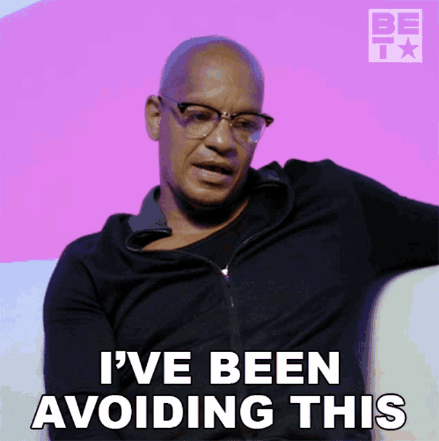 a man with glasses and a black jacket says " i 've been avoiding this "