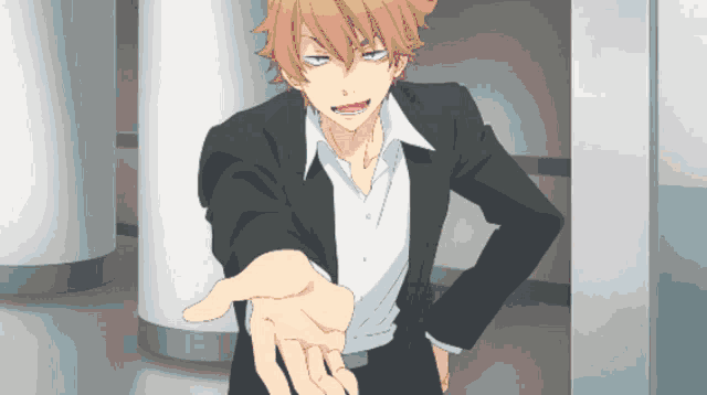 a man in a suit reaches out his hand towards the camera