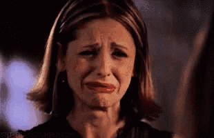 a woman is crying and making a funny face with her mouth open .