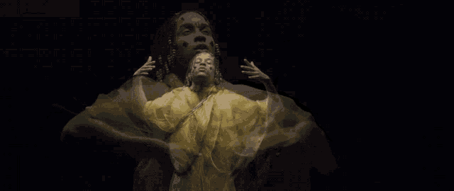 a man with dreadlocks is wearing a yellow and green dress