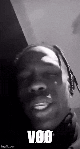 a black and white photo of a man with dreadlocks making a funny face