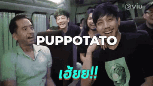 a group of men are laughing in a bus and the word puppetato is on the screen behind them