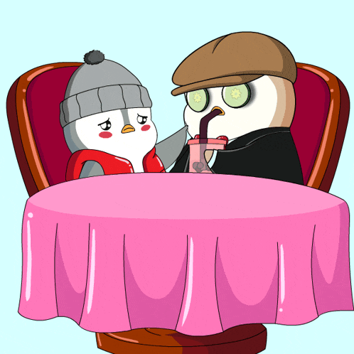 two penguins are sitting at a table drinking from a pink cup