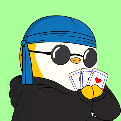 a penguin wearing sunglasses and a blue headband is holding a pair of playing cards