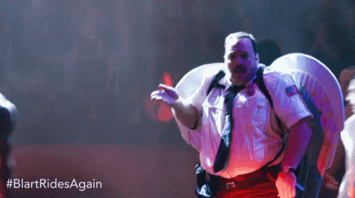 a man dressed as a police officer is dancing in a club .