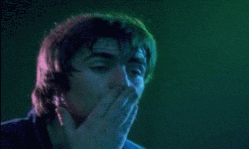 a close up of a man 's face with a green background