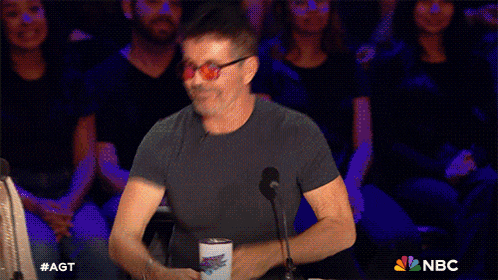 a man giving a high five in front of a crowd with nbc on the bottom right