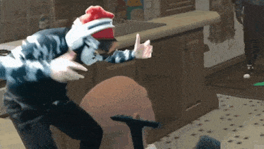 a man in a santa hat is giving a thumbs up