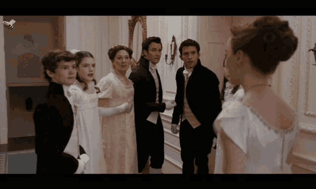 a group of people standing in a hallway with a bee on the bottom right