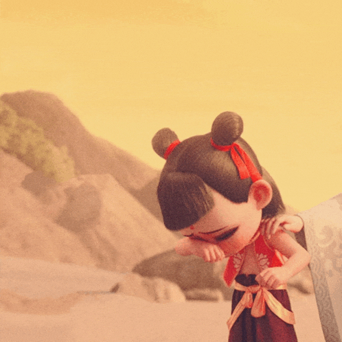 a little girl with a red bow in her hair is standing in front of a mountain