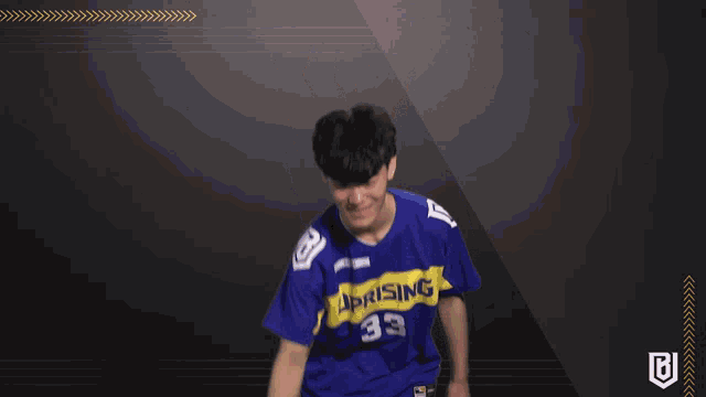 a man wearing a blue and yellow u-rising jersey