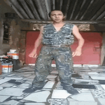 a man in a camouflage vest and pants is standing in front of a red door