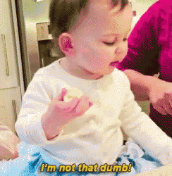 a baby says i 'm not that dumb while holding something