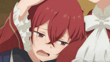 a close up of a girl with red hair and a bow tie