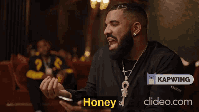 a man holding a cell phone with the words honey honey honey honey on the bottom