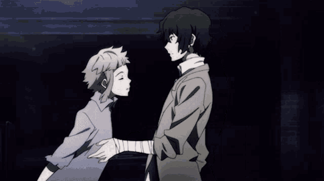 a man and a woman are standing next to each other looking at each other