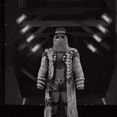 a black and white photo of a man wearing a mask