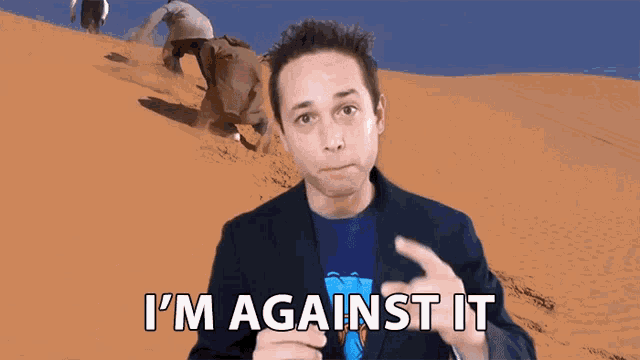 a man in a suit says i 'm against it in front of a desert scene