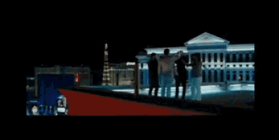 a group of people standing in front of a large building