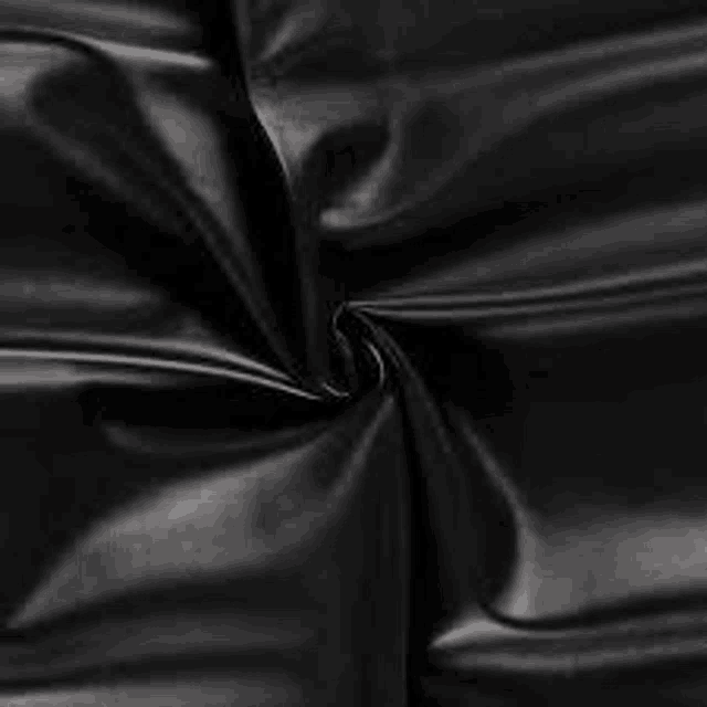it is a close up of a piece of black leather fabric .