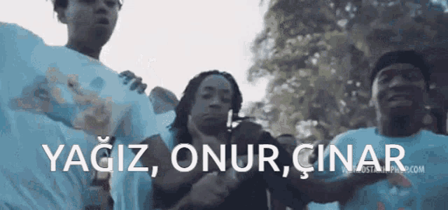 a group of people are standing in a line with the words " yagiz onur cinar " written on the bottom