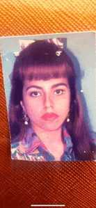 a close up of a woman 's face with long hair and earrings
