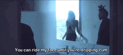 a man and a woman are standing in a bathroom looking at each other in a mirror .