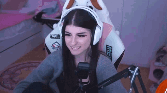 a girl wearing headphones and a chair that says me