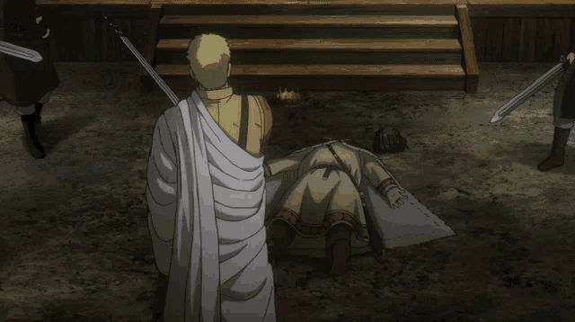 a man in a white robe is standing next to a man laying on the ground with a sword in his hand