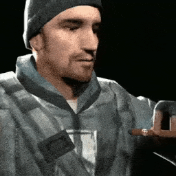 a man wearing a beanie is holding a cigar in his hand .