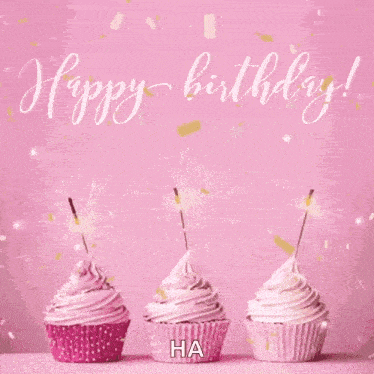 three pink cupcakes with sparklers on a pink background with the words `` happy birthday '' written on it .