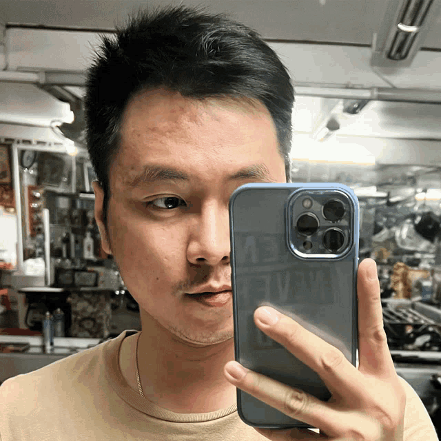 a man is taking a picture of himself with a phone that says ev on it