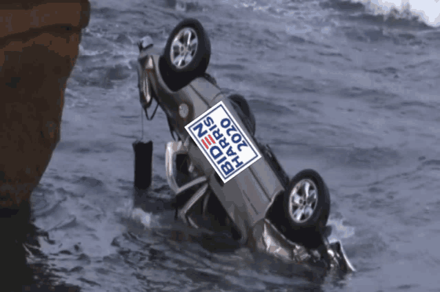 a car with a biden 2020 sign on it is in the water
