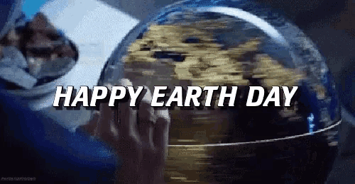 a person holding a globe with the words happy earth day written on it