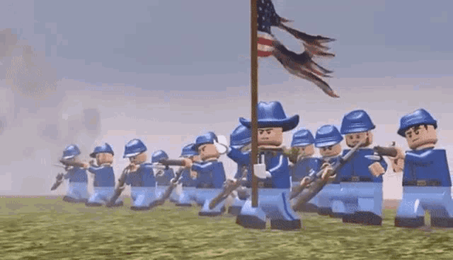 a group of lego soldiers marching in a line with guns and a flag .
