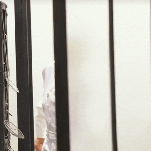 a woman in a white coat is standing in a room