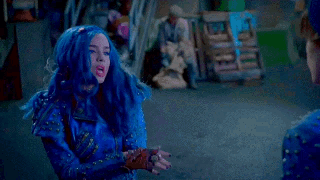 a man and a woman are standing next to each other and the woman has blue hair .